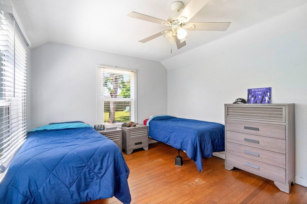 Furnished shared bedroom with two twin beds in a Hope to Haven home